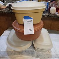 Stacked view of two round insulated servers and two lidded oval casseroles
