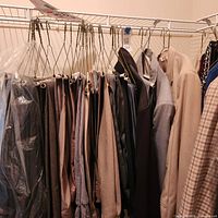 Closet rod with multiple pairs of men’s slacks in various colors