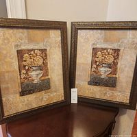 Pair of framed floral prints on table