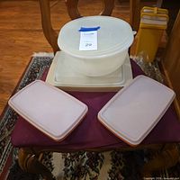 All plastic storage containers, lids and egg trays displayed together.