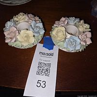 Top view of both porcelain candle holders showing applied pastel flowers