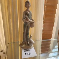 Front view of porcelain woman figurine with birds