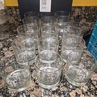 Front view of all 12 etched monogram F tumblers on countertop