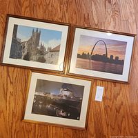 All three framed prints laid on floor showing images and frames