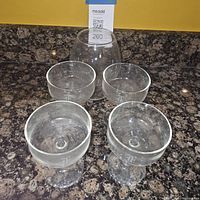 Four etched monogram coupe goblets around separate central holder