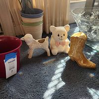 group shot of lamb planter, bear figurine, cowboy boot planter, pink pot