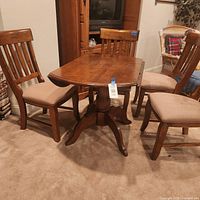 Table with chairs nearby for scale, leaf inserted