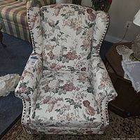Front view of floral wingback armchair