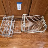 Group shot of all four white metal wire baskets