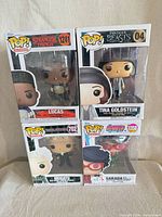 Front view of all four boxed Funko Pop! figures