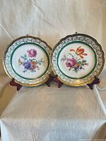 Both porcelain plates on stands showing full design