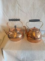 Both copper teapots side by side