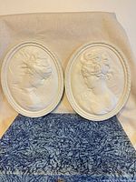 Both oval plaques side by side front view