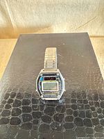 Front view of Sanyo stainless steel digital watch on display stand