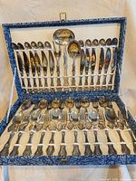 Open presentation case showing full 51-piece flatware set