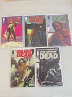 Group shot of all five bagged Walking Dead Weekly comics on tabletop