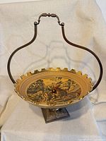 Full view of brass compote with handle attached
