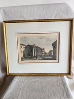 Framed print on stand showing full view with mat and frame