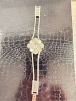 Front view showing entire bracelet watch and floral case