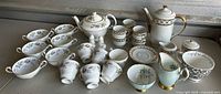Overview of entire tea and coffee set laid out on table