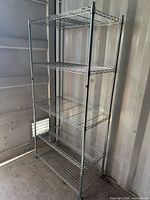 Front view of full shelving unit showing five shelves and chrome finish
