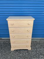 Front view showing five drawers and knob pulls