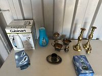 Entire lot on shelf: boxed kettle, blue vase, silverplate pieces, brass candlesticks, soapstone carving, boxed crystal ornament
