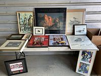 Overview of all framed prints, posters, plaques on table