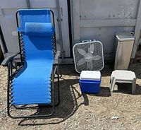 Group shot of all five items: lounge chair, box fan, cooler, trash can, step stool
