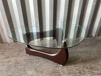 Full view of coffee table showing glass top and wood base