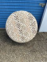 Top view of round ottoman showing floral jacquard pattern and overall diameter