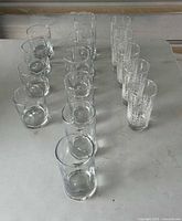 All 15 glasses arranged on table showing plain and etched examples
