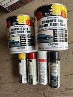 Full lot showing two Solignum gallon cans and four ArmorCoat spray cans