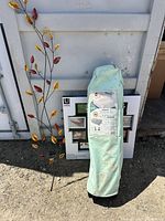 All three items together: VersaLite carry bag, Umbra frame in box, metal vine