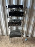Full view of four components stacked on wire rack
