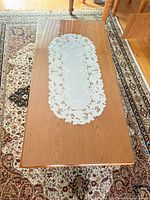 Top view showing wood surface under clear glass and overall rectangular shape
