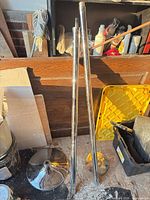 Two chrome poles and two chrome discs shown together