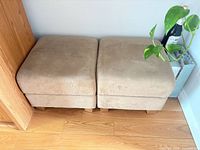 Pair of beige square ottomans side by side