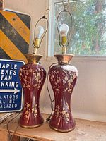 Full view of both matching burgundy floral lamps with harps, sockets, no shades