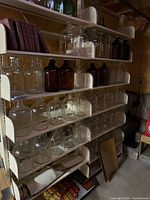 Shelves filled with clear and brown glass jugs