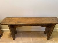 Front view of solid wood bench showing full structure
