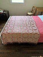 Full view of brocade throw spread over queen bed showing pattern and size