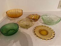 All six coloured glass serving pieces displayed on countertop