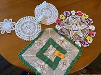 All seven crochet doilies displayed on tabletop