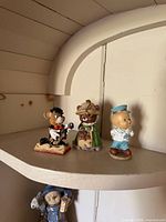 Front view of three figurines on shelf