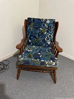 Front view of wooden armchair with cushions