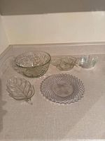 Overview of all six clear glass pieces on countertop