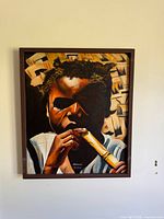 Front view of framed Haitian painting on wall