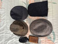 Top view of four hats and two wallets