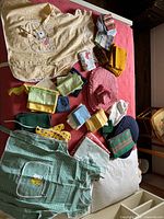 Overview of aprons, napkins, placemats, potholders and towels spread on surface